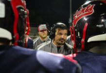
			
				                                Head Coach Stephen Allard coaching up the Southern Wayne Saints defense on a timeout. (Kareem Brown photo)
 
			
		