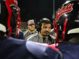 Saints fall to Warriors in Friday night football action 
			
				                                Head Coach Stephen Allard coaching up the Southern Wayne Saints defense on a timeout. (Kareem Brown photo)