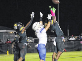 
			
				                                Raider Jayden Stox goes up looking to haul in a touchdown in the end zone against two James Kenan defenders.
 
			
		