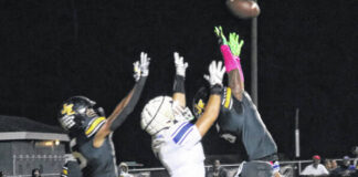 
			
				                                Raider Jayden Stox goes up looking to haul in a touchdown in the end zone against two James Kenan defenders.
 
			
		