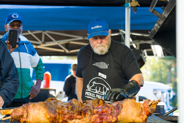 <p>Cook-off Judge Tim Croom judges a Pickles, Pigs & Swigs BBQ entry during the 2024 Pickles, Pigs & Swigs. This year’s event returns Nov. 7-8 in downtown Mount Olive.</p>