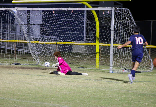 <p>Saints’ No. 10 Jaime Martinez nets the second goal of the match, capitalizing as the Red Wolves’ keeper can’t make the save. (Kareem Brown|mountolivetribune.com)</p>