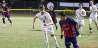 
			
				                                No. 25 Otoniel Aguilon shows control downfield, navigating through multiple Red Wolves defenders. (Kareem Brown|mountolivetribune.com)
 
			
		