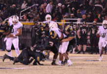 Battle in Warsaw: James Kenan Tigers vs. Kinston Vikings
A strong defensive stand as multiple James Kenan Tigers combine for a big tackle against a Kinston runner. (Kareem Brown|mountolivetribune.com)