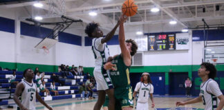 
			
				                                Gators No. 23 Cedric Lawson, delivers a strong block against Rebels No. 50 Noah Bennett. (Kareem Brown|mountolivetribune.com)
 
			
		