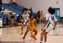 Tigers roar past Gators in dominant FCA Tournament victory
James Kenans No. 3 Jeremiah Hall drives the ball up the court against the Gators defenders. (Kareem Brown|mountolivetribune.com)