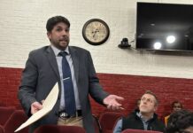 
			
				                                FCA Area Director Ronnie Wise and others listen as Mount Olive Attorney John Ryan addresses the board on behalf of the Mount Olive Hurricanes. (Georgia Dees|mountolivetribune.com)
 
			
		