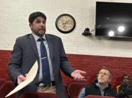 
			
				                                FCA Area Director Ronnie Wise and others listen as Mount Olive Attorney John Ryan addresses the board on behalf of the Mount Olive Hurricanes. (Georgia Dees|mountolivetribune.com)
 
			
		