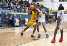
			
				                                James Kenans No. 2 Zamarion Smith attacks the basket driving through Cougar No. 4 Maurice Tyler for a layup.
 
			
		