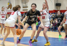 
			
				                                North Duplins No. 10 Maggie Brown fighting to keep possession of the ball with heavy defense by the Eagles.
 
			
		