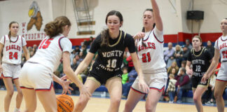 
			
				                                North Duplins No. 10 Maggie Brown fighting to keep possession of the ball with heavy defense by the Eagles.
 
			
		