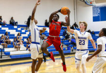 
			
				                                Southern Wayne Saints No. 1 Jaylen Carr passes Warriors defenders with slick moves for a very contested layup. (Kareem Brown|mountolivetribune.com)
 
			
		