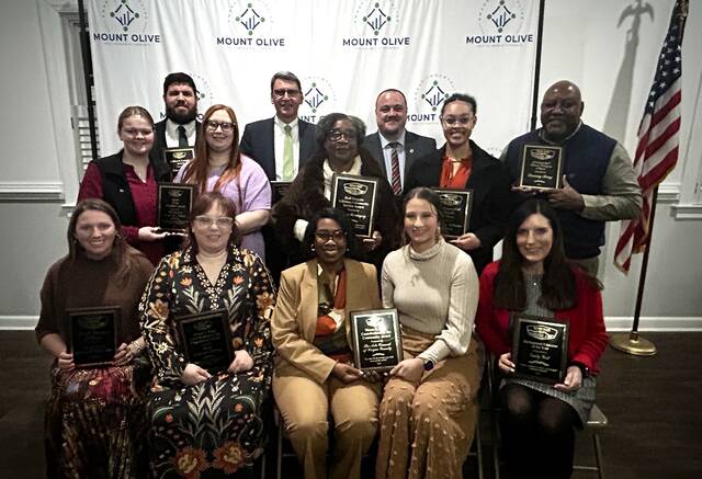 <p>Chamber Award Winners are (front row, left to right) Emma Smith, Front Porch Florist and Gifts; Lauren Saeger, Steele Memorial Library; Ayisha Razzak-Ellis and Anna Hinson, Arts Council of Wayne County; Emily West; (middle row, left to right) Emily Hodges and Amber Coe, UMO CFFA; Carrie Kornegay, Deaonna Williams, Danny King (back row, left to right) Edward Olive, Dr. Ed Croom, UMO President; Jason Hughes, Mount Olive Police Chief. (Georgia Dees|mountolivetribune.com)</p>