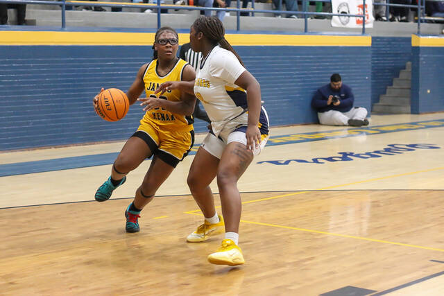 James Kenans No. 32 Aleyah Wilson drives to the basket for a contested layup while Goldsboros No. 42 Aziyah Boyer of steps in to defend. (Kareem Brown|mountolivetribune.com)