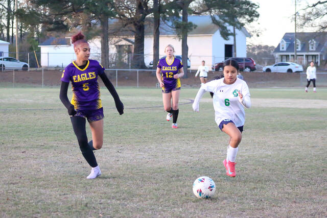Spring Creeks No. 6 Anahi Solis fights for control, going head to head with Rosewoods No. 5 Tiffany Philippi in a fierce battle for possession. (Kareem Brown|mountolivetribune.com)