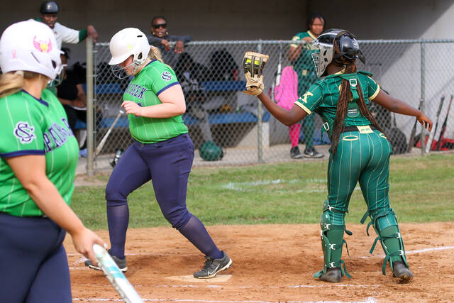 Spring Creeks No. 14 Leah Witmire, scores as the Kinston catcher receives the ball just shy on the play. (Kareem Brown|mountolivetribune.com)