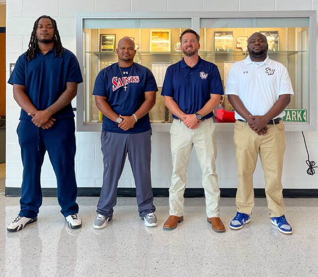 Saints Mens Basketball Coaches, left to right, are Jamal King (assistant coach), Christopher Davis (assistant coach), Austin Hood (head coach), and Dwight Smith Jr. (assistant coach).