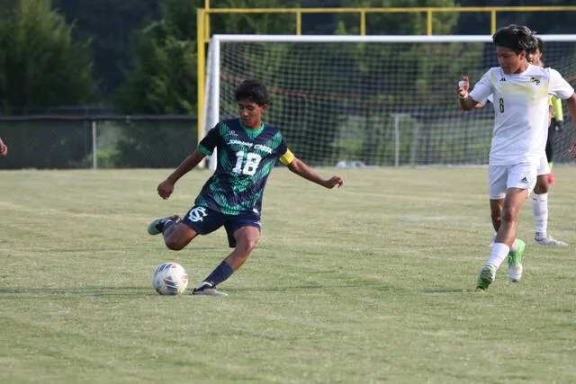 Spring Creeks No. 18 Jose Medina Osorto with a clear opening to the ball and kick for the pass.