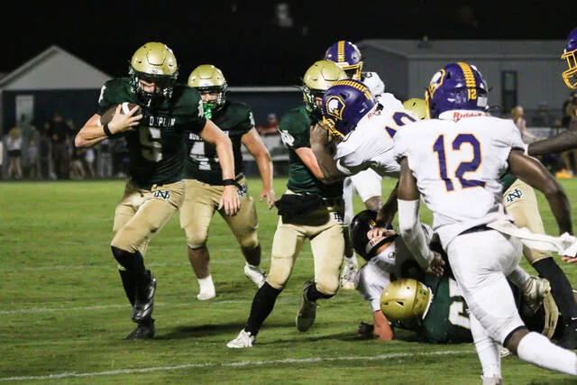 North Duplins workhorse No. 5 Jayden Pope running the ball with power as he moves through the Eagles backfield.